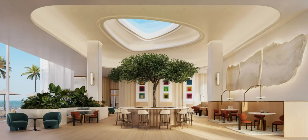 Bright, grand lobby at Viceroy Residences FTL with high ceilings, lush greenery and modern luxury seating.